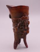 A small three footed libation cup. 8.5 cm high.