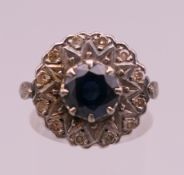 A 10 ct gold diamond and sapphire cluster ring. Ring size M. 6 grammes total weight.