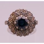 A 10 ct gold diamond and sapphire cluster ring. Ring size M. 6 grammes total weight.