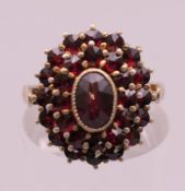 A silver and garnet ring. Ring size N/O.