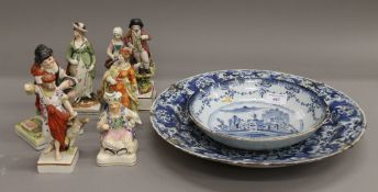 A quantity of Staffordshire figures and two Delft dishes.