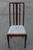 A set of four Edwardian mahogany dining chairs.