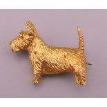 A silver gilt Scottie dog form brooch. 2.5 cm long x 2.25 cm high.