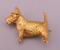 A silver gilt Scottie dog form brooch. 2.5 cm long x 2.25 cm high.