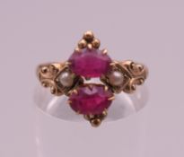 A 10 K gold, ruby and seed pearl ring. Ring size O/P. 1.6 grammes total weight.