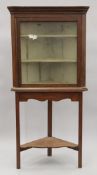 A mahogany glazed corner cabinet on stand. 82 cm wide x 169 cm high.