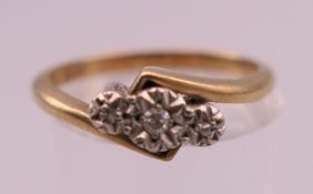 A 9 ct gold and platinum three stone diamond ring. Rings size N/O. 2.4 grammes total weight.