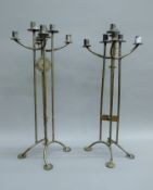 A pair of Arts and Crafts style wrought iron candlesticks. 55 cm high.