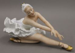 A Continental porcelain model of a ballerina. 25 cm long.