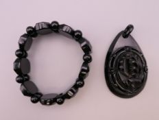 A Whitby Bay jet expanding bracelet and a pendant. The pendant 7 cm high.