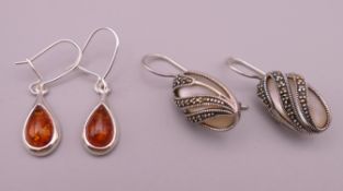 Two pairs of silver earrings. 1.5 cm high and 2 cm high excluding suspension loops.