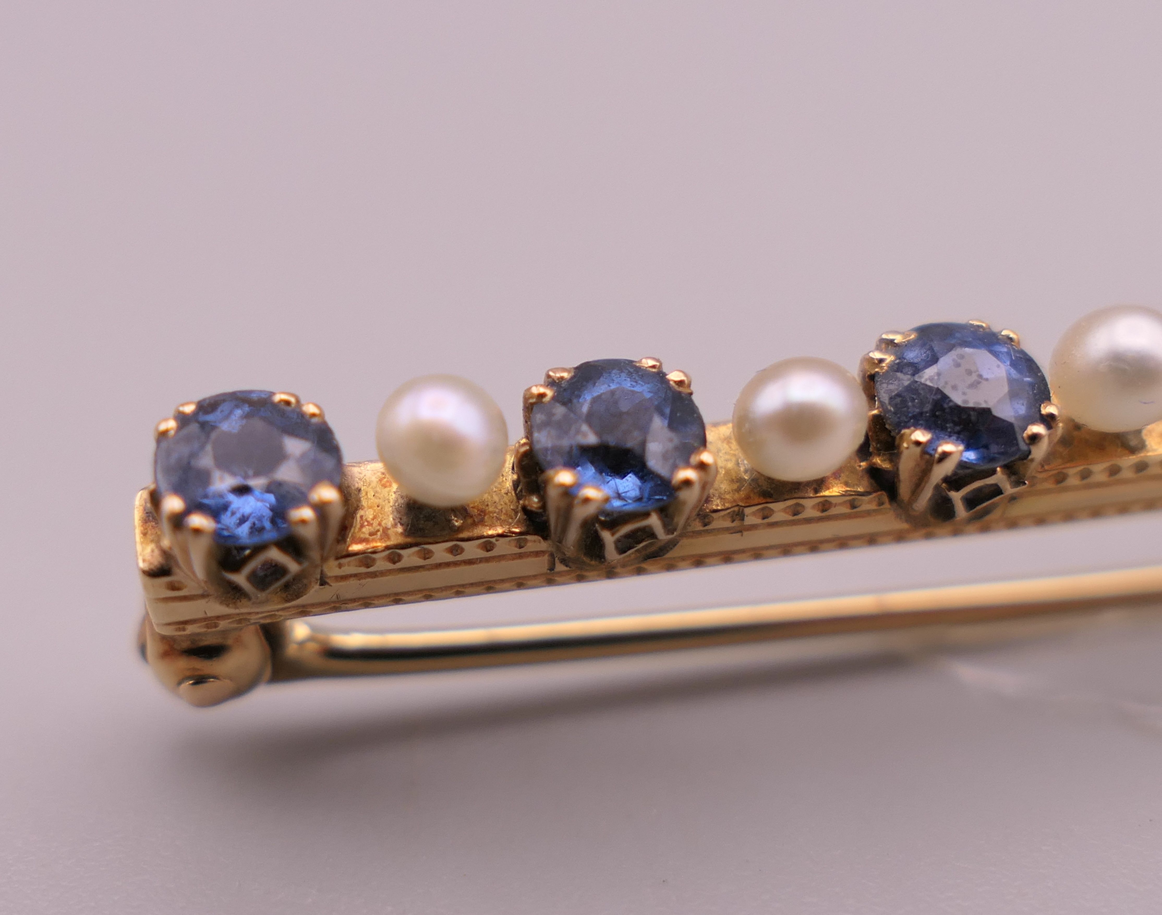 An antique natural sapphire and seed pearl unmarked gold (high carat tested) brooch, boxed. - Image 4 of 10
