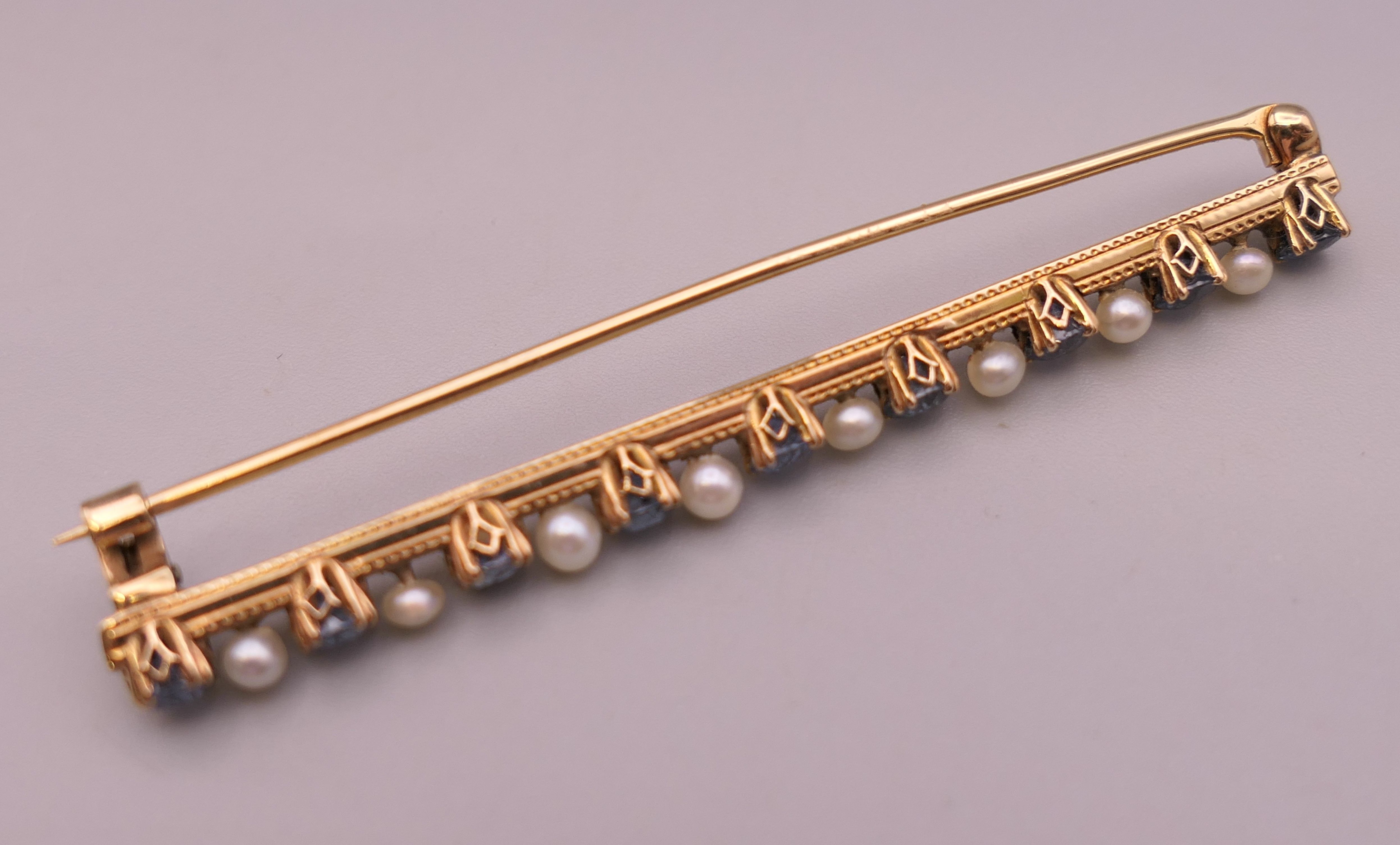 An antique natural sapphire and seed pearl unmarked gold (high carat tested) brooch, boxed. - Image 6 of 10