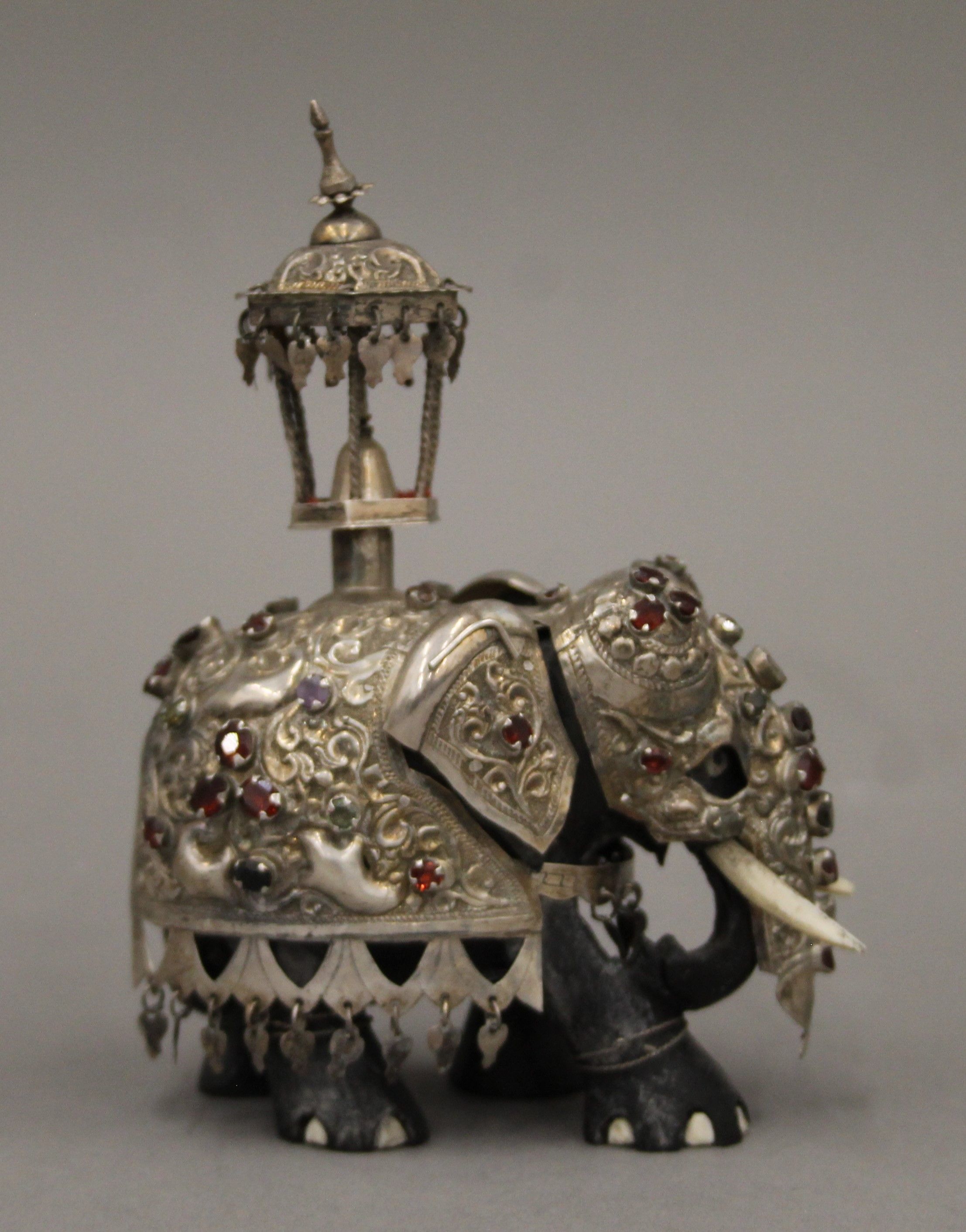 A carved ebony and bone model of an elephant clad in stone set unmarked silver. 12.5 cm high. - Image 2 of 4