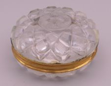 A 19th century unmarked gold mounted cut crystal glass box. 6 cm diameter.