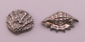 Two unmarked silver shell form brooches. 5 cm wide and 3.5 cm wide.