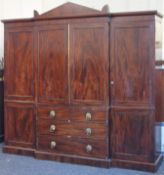 A 19th century mahogany compactum wardrobe. 230 cm high x 243 cm wide.