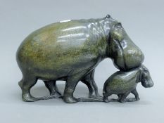 A carved soapstone model of hippos. 29 cm long.