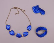 Two Scandinavian enamel and silver brooches and a necklace. Necklace 42 cm long.