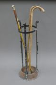 An early 20th century stick stand, containing various sticks. The former 68 cm high.