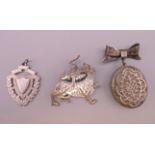 A silver locket brooch, a silver shield form pendant and a silver brooch. Locket including bow 5.