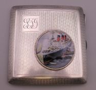 A silver cigarette case with roundel depicting a steam ship. 8 cm x 7.5 cm.