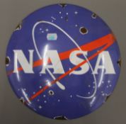 An enamel NASA sign. 29 cm diameter.