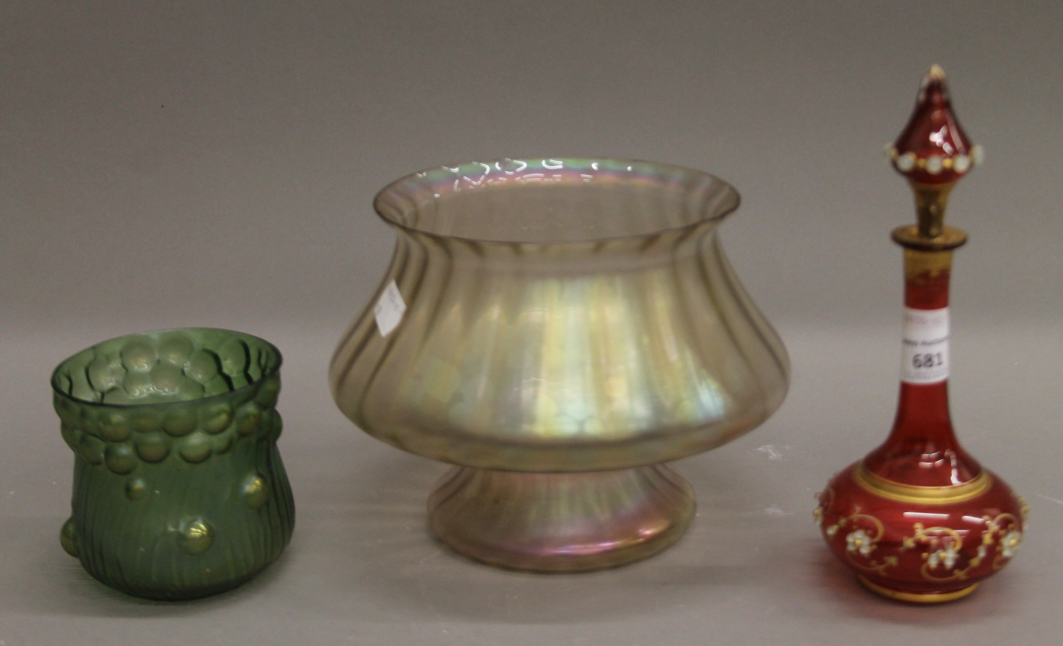 A Bohemian glass scent bottle and two iridescent vases. The former 20.5 cm high.