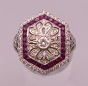 An 18 ct white gold Art Deco style ruby and diamond ring. Ring size M/N. 5.5 grammes total weight.