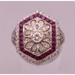 An 18 ct white gold Art Deco style ruby and diamond ring. Ring size M/N. 5.5 grammes total weight.