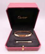 A Cartier four stone diamond set 18 ct gold 'Love' bracelet, signed,