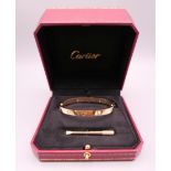 A Cartier four stone diamond set 18 ct gold 'Love' bracelet, signed,