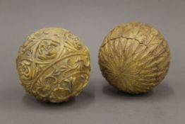 Two ovoid carvings, possibly coconuts. The largest approximately 9.5 cm high.