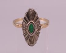 A 9 ct gold, emerald and diamond navette ring. Ring size T/U. 4.2 grammes total weight.