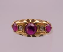 An 18 ct gold ruby and diamond ring. Ring size K. 3.1 grammes total weight.