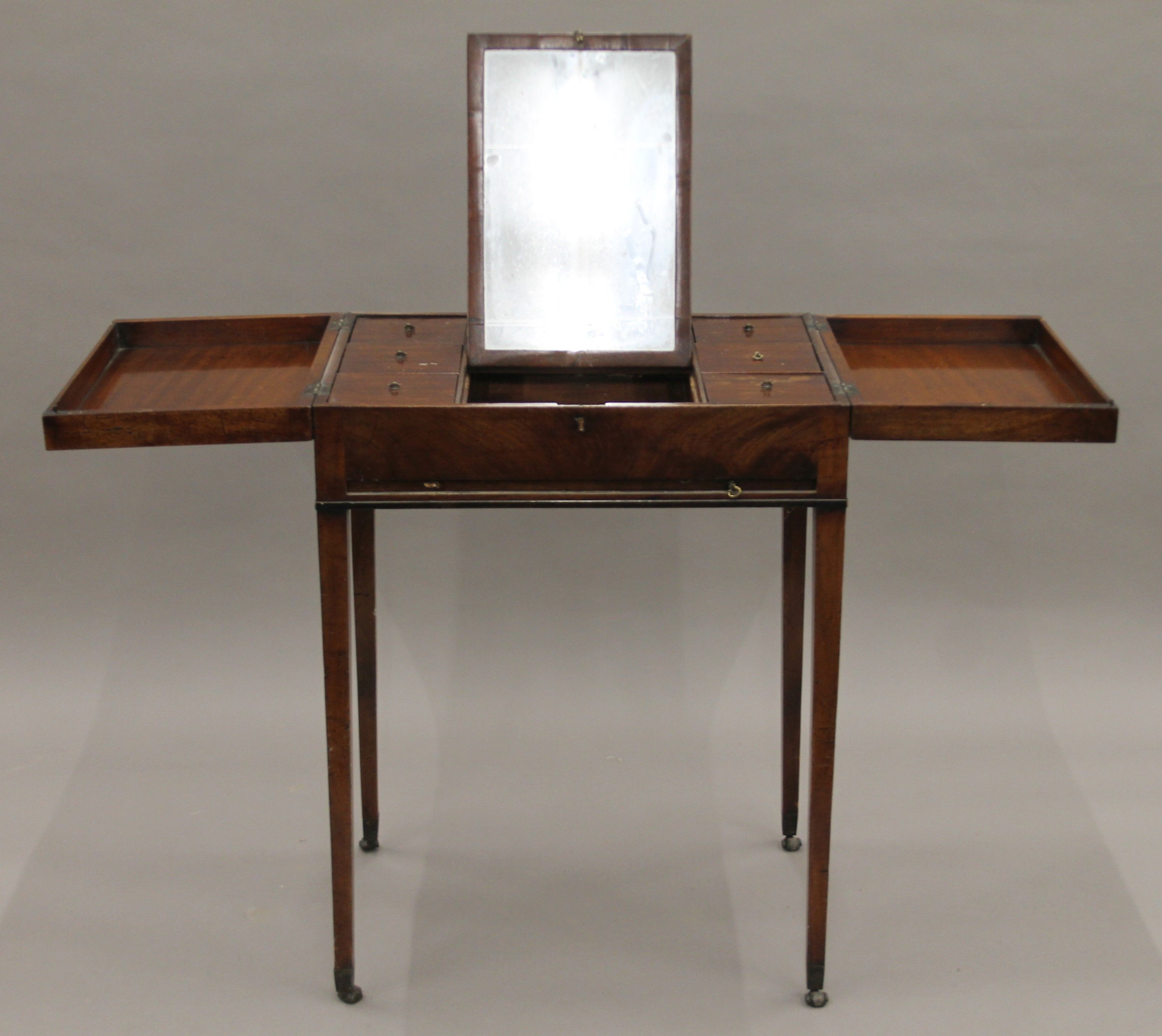 A 19th century mahogany gentleman's fold over dressing table. 63 cm wide.