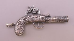 A miniature silver pistol form pendant. 6 cm long excluding suspension loop.