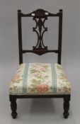 An Edwardian nursing chair. 44 cm wide.