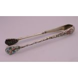 A pair of Russian silver and enamel tongs. 14 cm long.