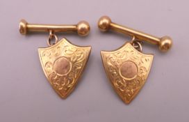 A pair of Chinese 18 ct gold shield form cufflinks. 1.75 cm high. 3.4 grammes.