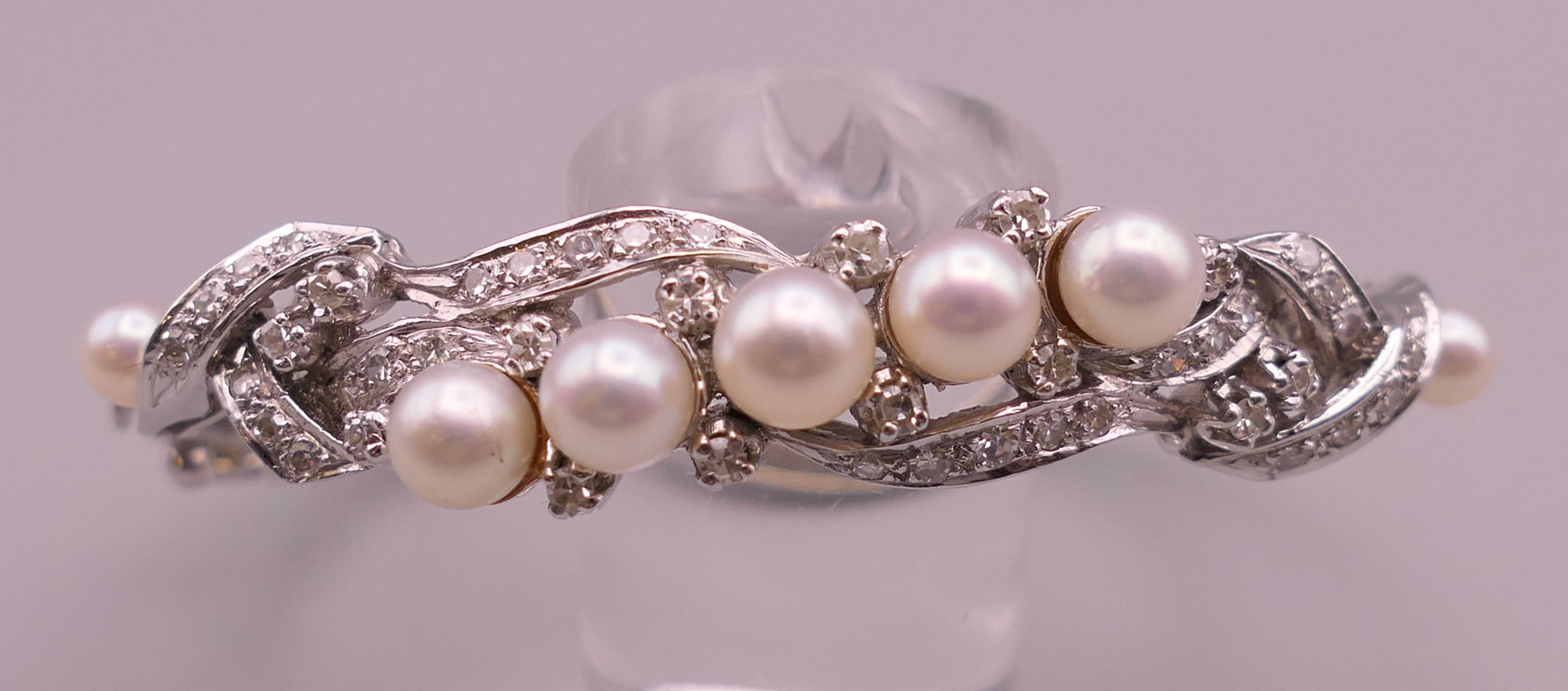 A 14 K white gold diamond and pearl bangle. 5 cm internal diameter. 16.5 grammes total weight. - Image 4 of 7