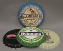 Four drink bottle top signs. Approximately 40 cm diameter.