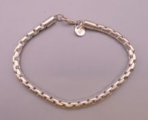 A silver bracelet. 20 cm long.