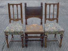 A pair of late 19th century walnut chairs and a carved oak side chair.