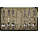 A boxed set of six Liberty and Co enamelled decorated silver teaspoons and matching tongs.