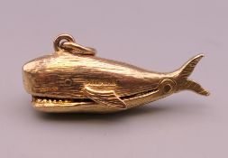 A 9 ct gold Jonah and the Whale charm. 2.5 cm long. 2.9 grammes.