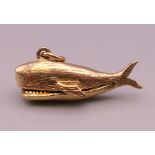 A 9 ct gold Jonah and the Whale charm. 2.5 cm long. 2.9 grammes.