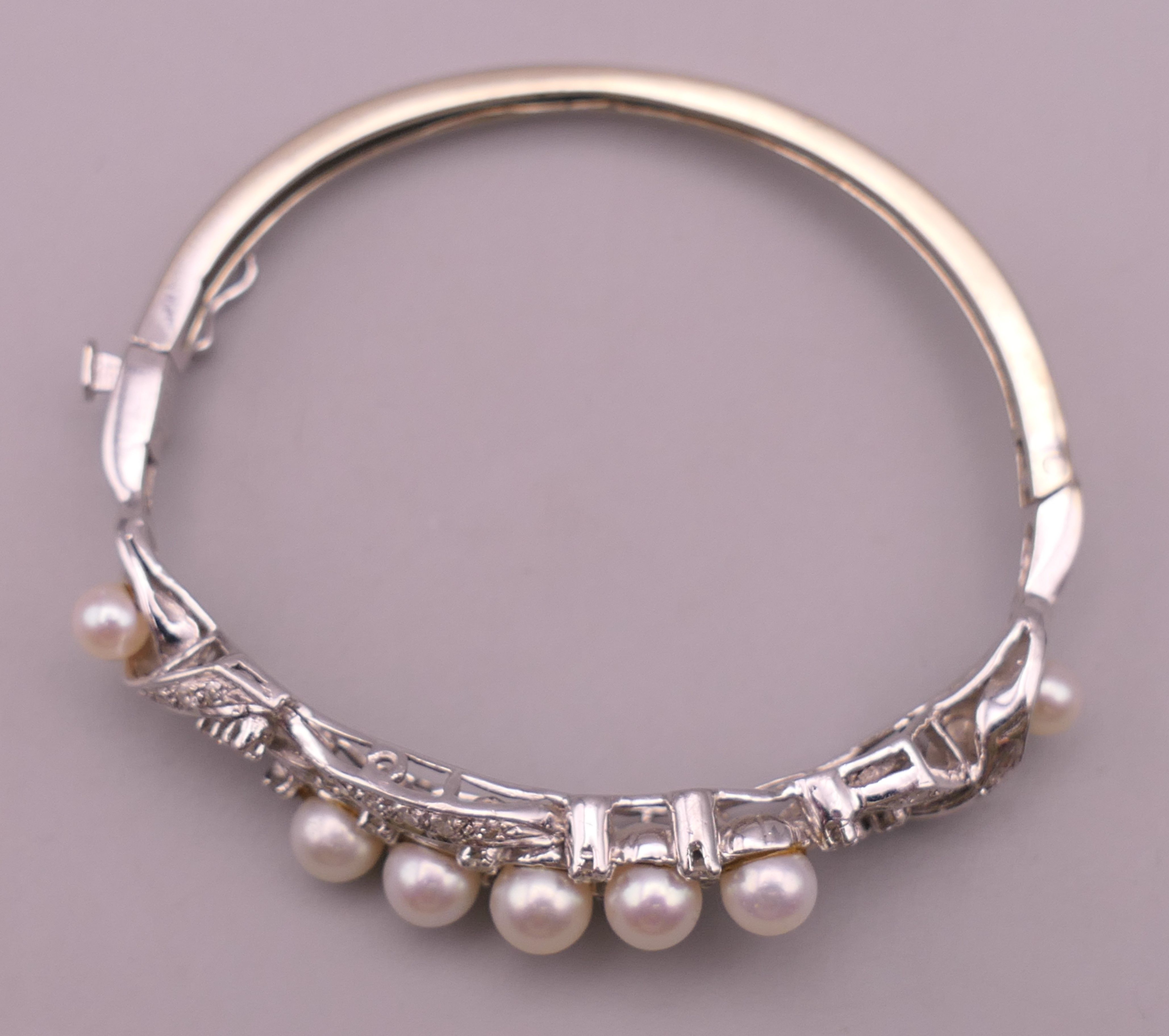A 14 K white gold diamond and pearl bangle. 5 cm internal diameter. 16.5 grammes total weight. - Image 2 of 7
