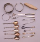A quantity of silver items, including bracelets, sugar tongs, five Apostle spoons, etc.