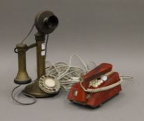 A brass candlestick telephone and a leather clad telephone. The former 31 cm high.